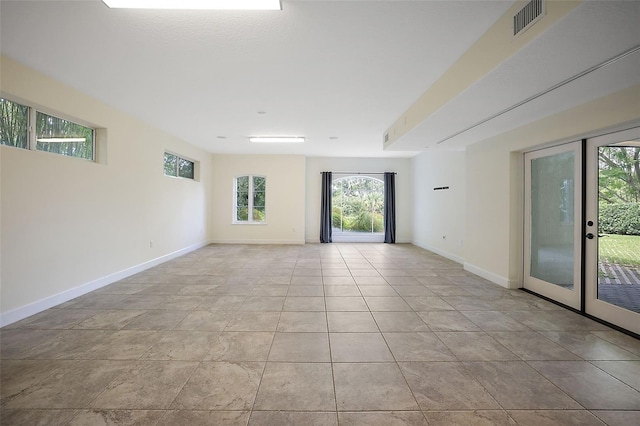 tiled empty room with french doors