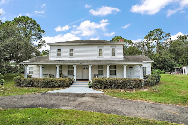 view of front of property with a porch and a front yard