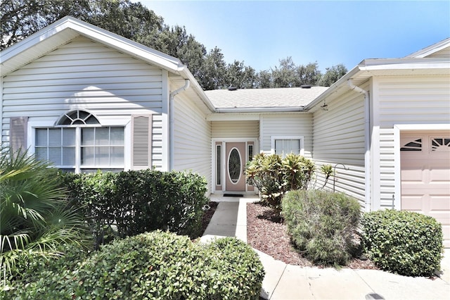 view of exterior entry featuring a garage