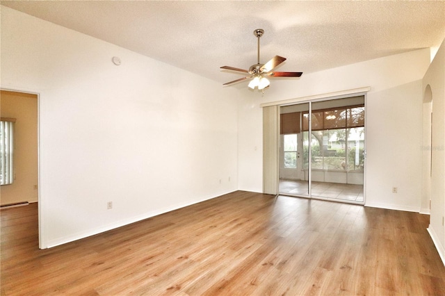 spare room featuring ceiling fan, light hardwood / wood-style floors, and a textured ceiling