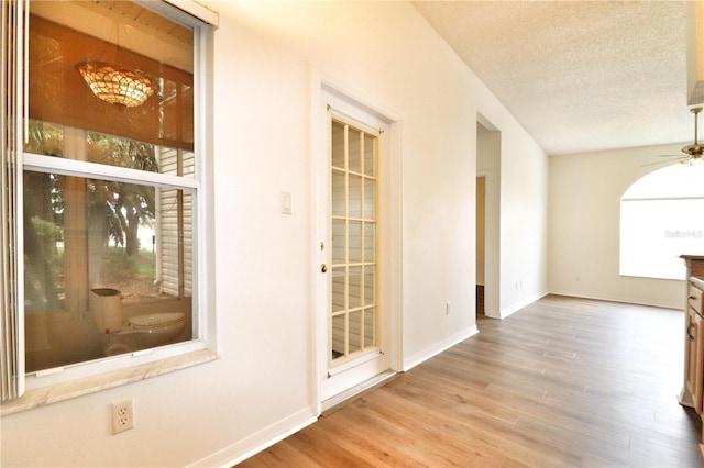 interior space with a textured ceiling and light wood-type flooring