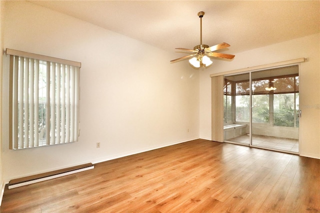 spare room with hardwood / wood-style flooring, ceiling fan, and a baseboard heating unit