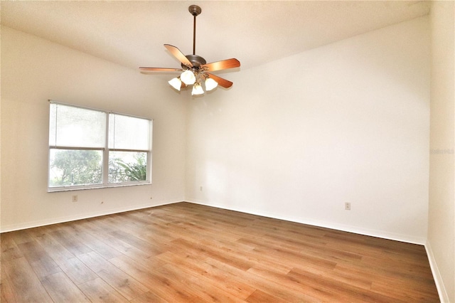 spare room with ceiling fan, wood-type flooring, and lofted ceiling