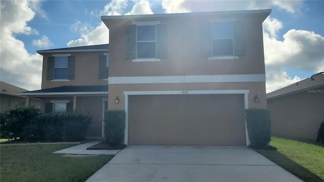 view of front of home with a front lawn and a garage