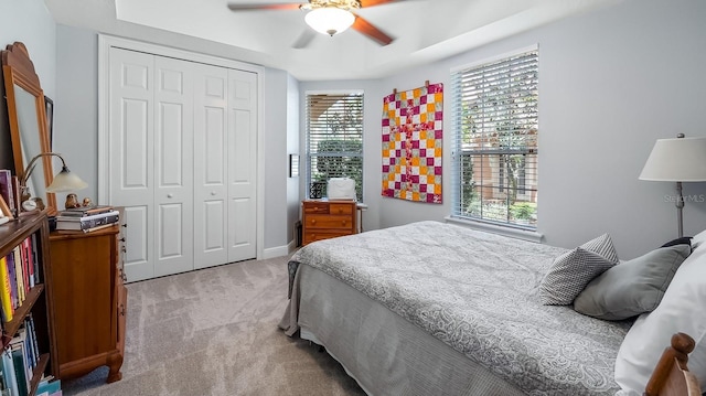 carpeted bedroom featuring a closet and ceiling fan