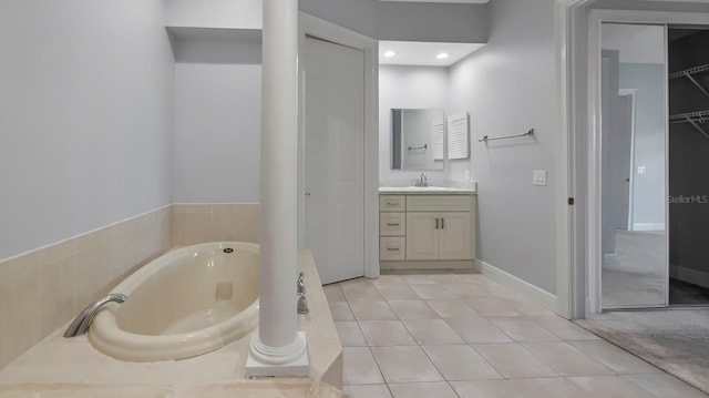 bathroom featuring tile patterned floors, vanity, and a tub