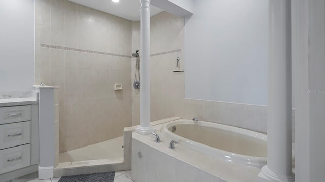 bathroom featuring vanity, shower with separate bathtub, and tile patterned flooring