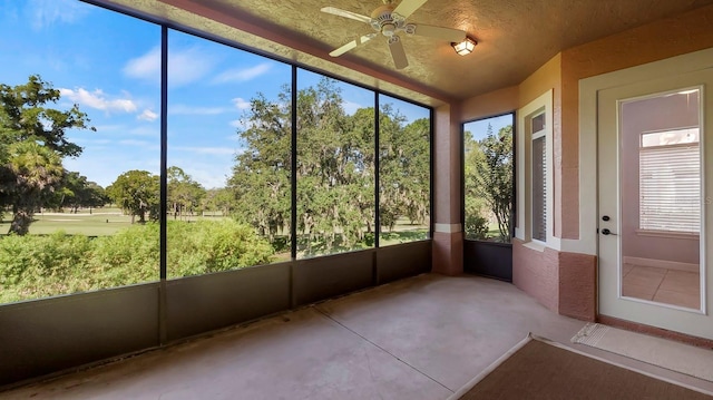 unfurnished sunroom featuring ceiling fan