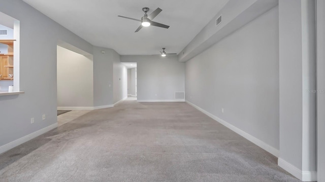 carpeted spare room with ceiling fan