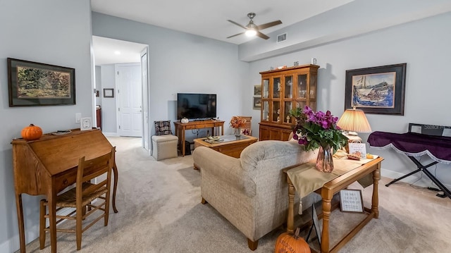 carpeted living room featuring ceiling fan