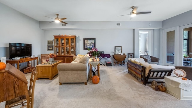 carpeted living room featuring ceiling fan