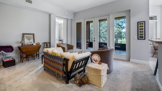 sitting room featuring carpet and french doors