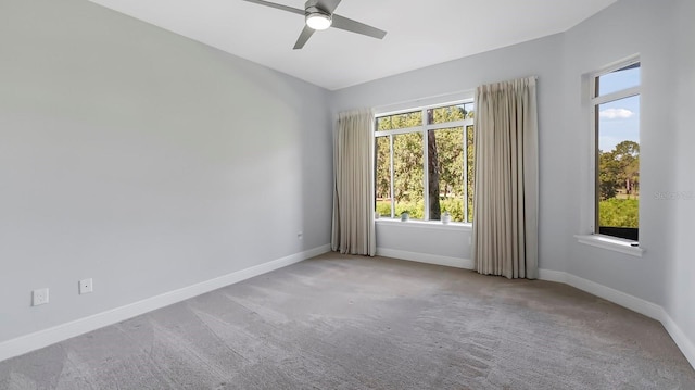 carpeted spare room with ceiling fan