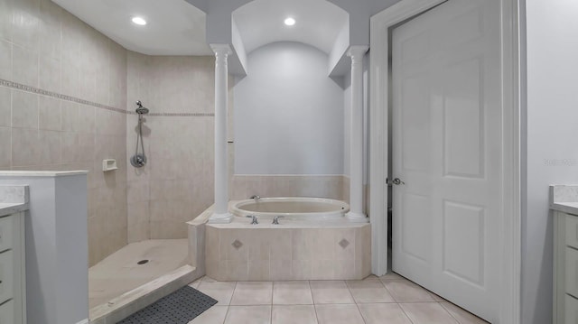 bathroom featuring vanity, shower with separate bathtub, and tile patterned flooring