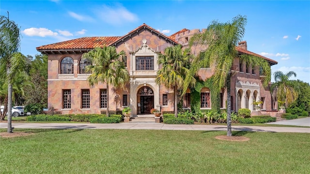 mediterranean / spanish-style home with a front lawn