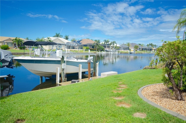 dock area with a water view and a lawn