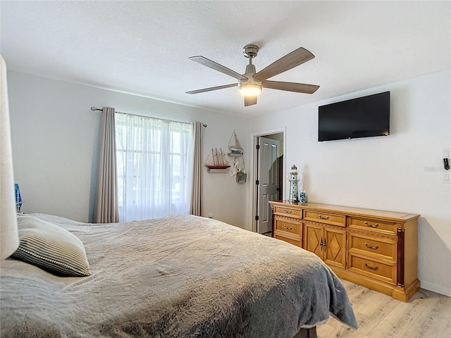 bedroom with ceiling fan and light hardwood / wood-style floors