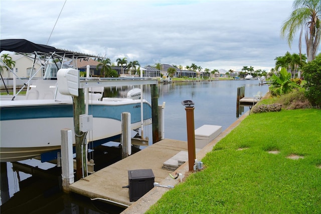 dock area with a yard and a water view