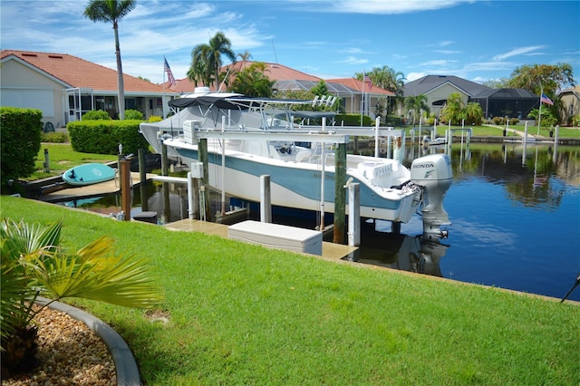 view of dock with a water view and a yard