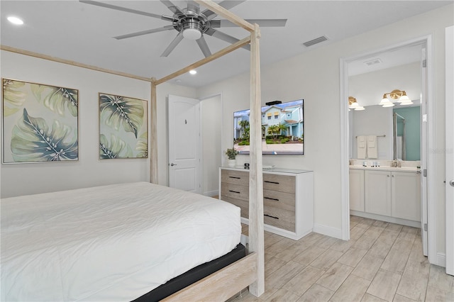 bedroom with connected bathroom, ceiling fan, and light wood-type flooring