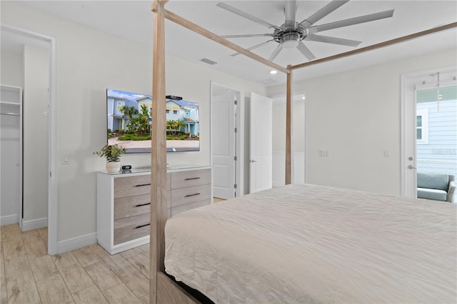 bedroom with ceiling fan, light wood-type flooring, and multiple windows