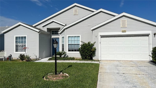 view of front of home with a front yard and a garage