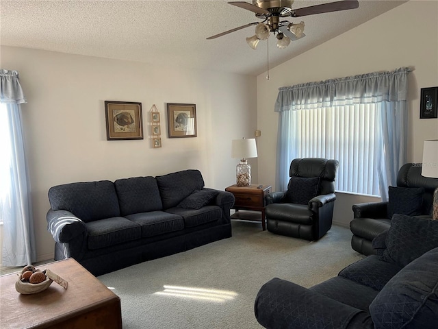 carpeted living room with ceiling fan, a textured ceiling, and vaulted ceiling