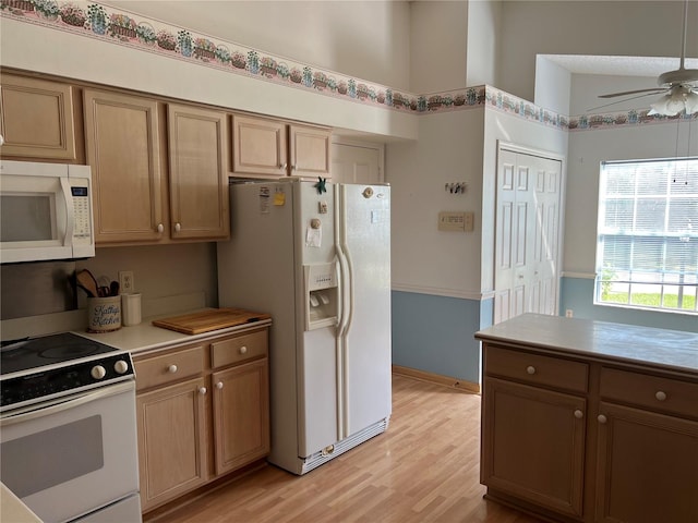 kitchen featuring light hardwood / wood-style flooring, white appliances, and ceiling fan