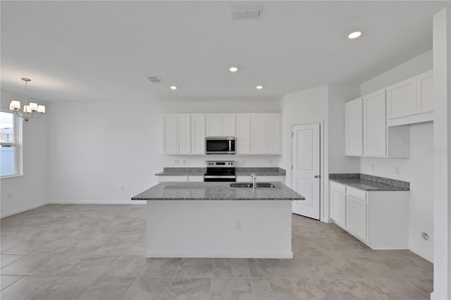 kitchen featuring white cabinetry, stainless steel appliances, a kitchen island with sink, and sink