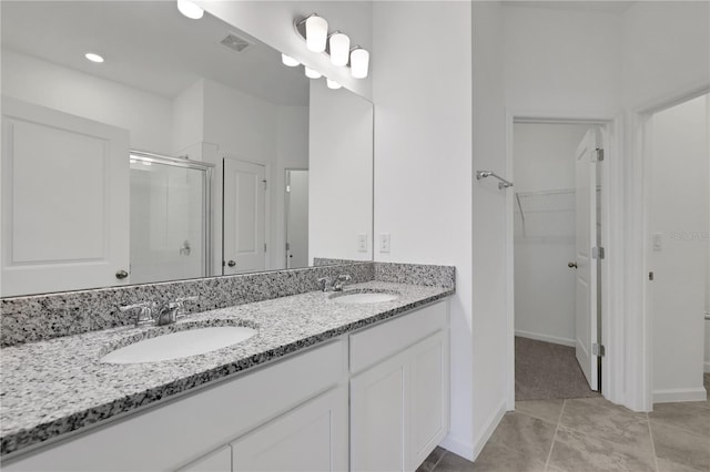 bathroom with vanity, tile patterned floors, and a shower with shower door