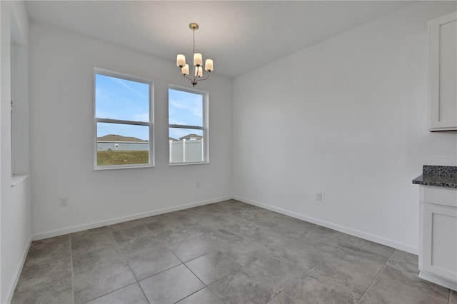 unfurnished dining area featuring a notable chandelier and light tile patterned flooring