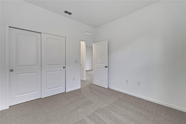 unfurnished bedroom featuring a closet and carpet floors