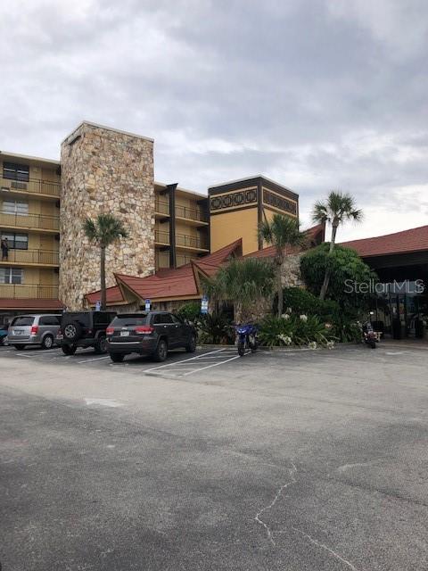 view of building exterior featuring uncovered parking