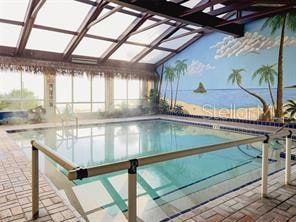indoor pool featuring a patio area and a lanai