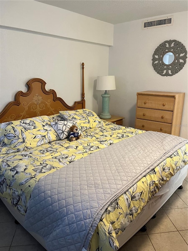 bedroom featuring visible vents and tile patterned flooring