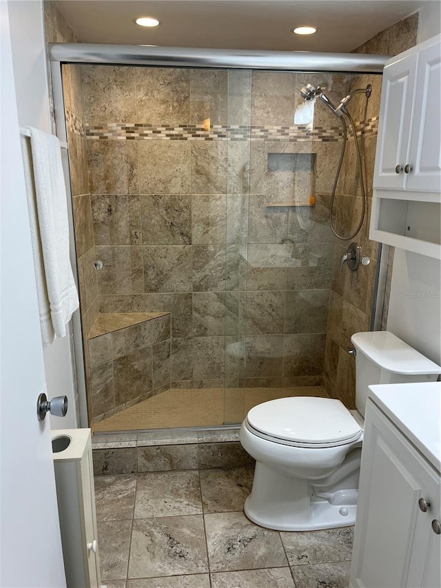 full bath with stone tile flooring, toilet, a shower stall, and recessed lighting
