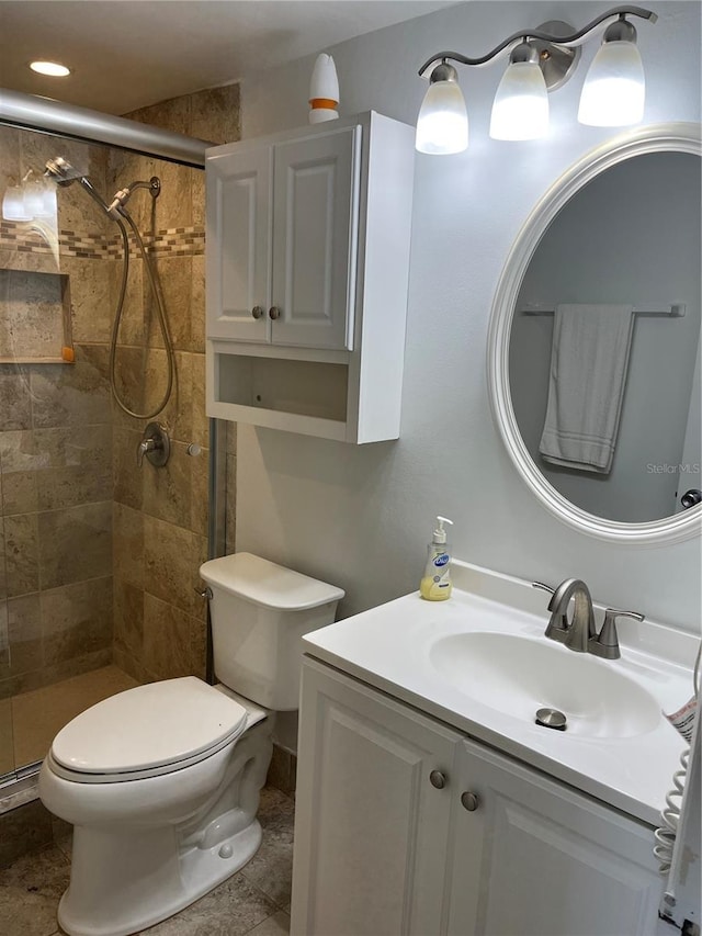 full bath featuring toilet, a stall shower, and vanity