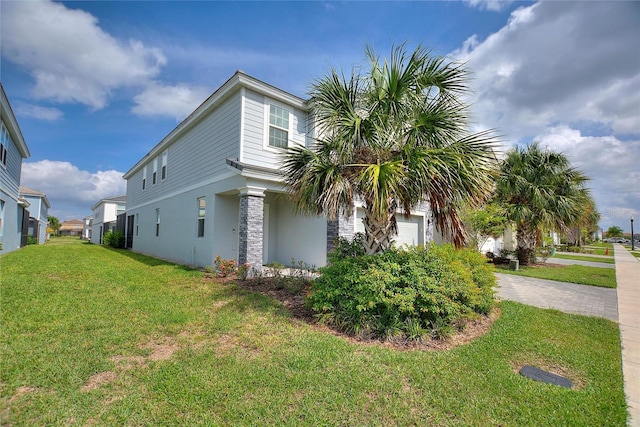 view of side of home with a lawn