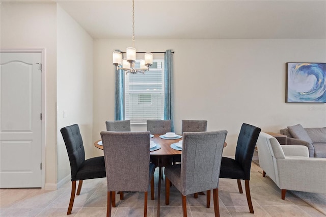 tiled dining area with a chandelier