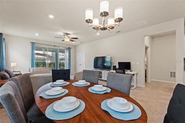 tiled dining space with ceiling fan with notable chandelier