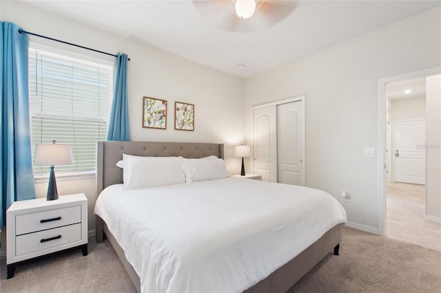 carpeted bedroom with a closet, ceiling fan, and multiple windows