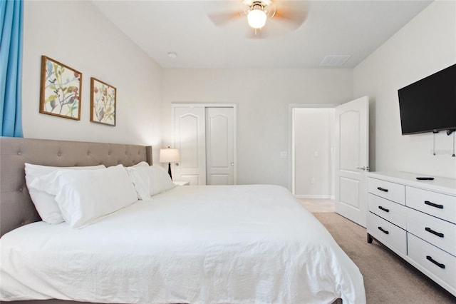 carpeted bedroom featuring a closet and ceiling fan