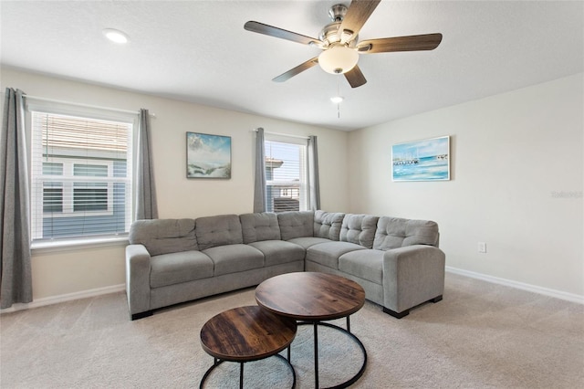 living room featuring light carpet and ceiling fan