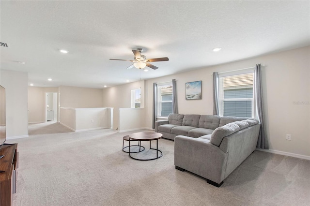 living room featuring light carpet and ceiling fan