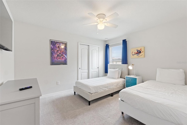 carpeted bedroom with a closet and ceiling fan