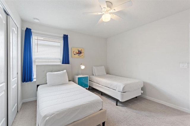 carpeted bedroom with a closet and ceiling fan