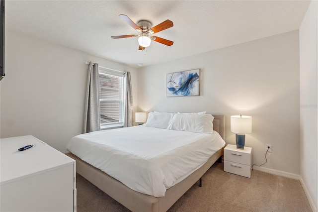 bedroom with ceiling fan and light colored carpet