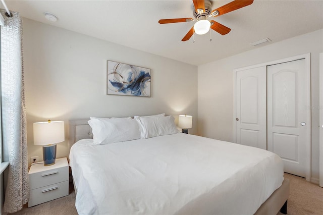 bedroom with light carpet, a closet, and ceiling fan