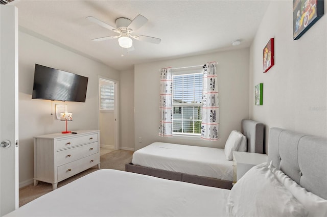 bedroom with ceiling fan and light colored carpet