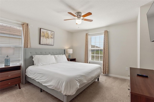 bedroom with light carpet and ceiling fan